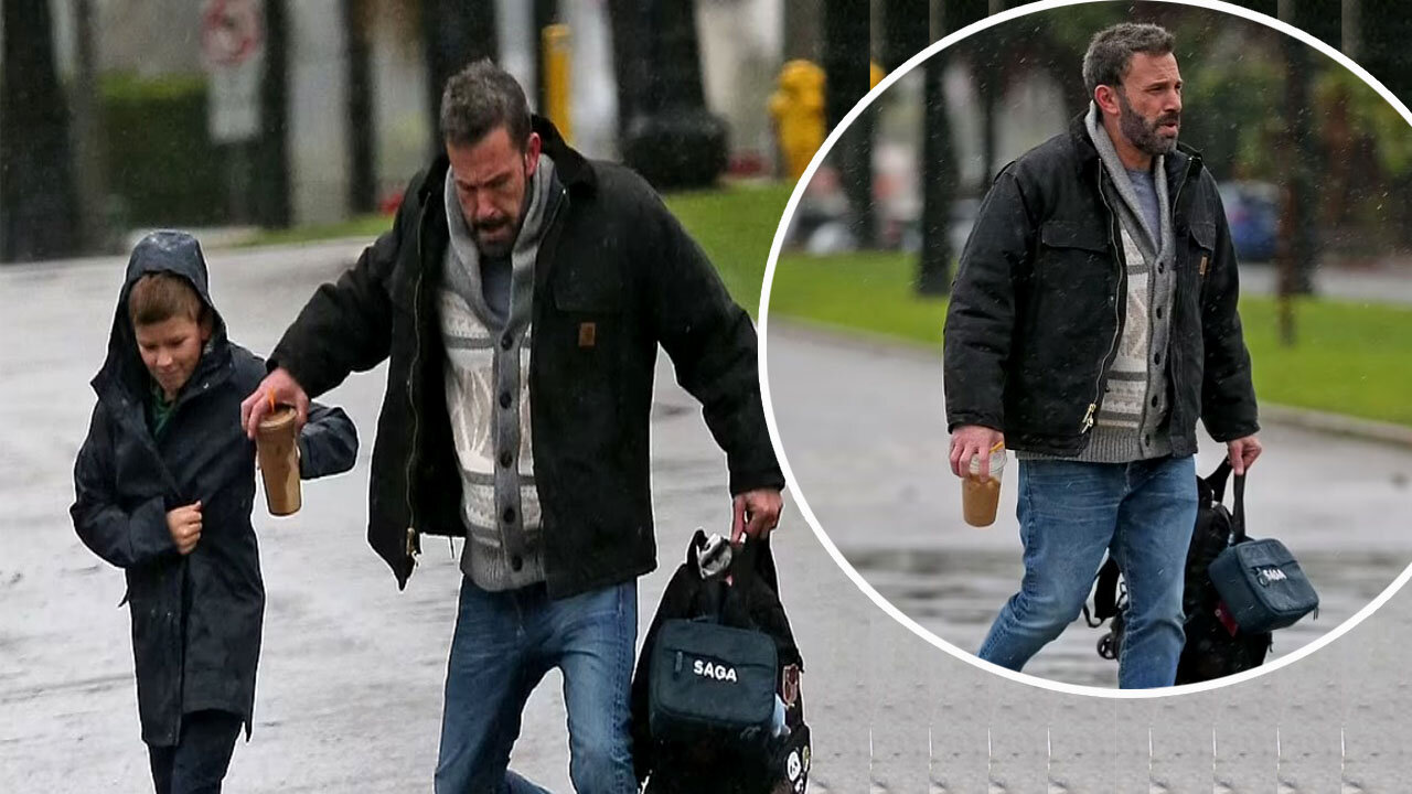 Ben Affleck soaks his Air Jordan sneakers as he walks with son Samuel in rainy Los Angeles