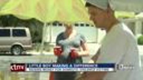 Little boy holds lemonade stand for domestic violence shelter