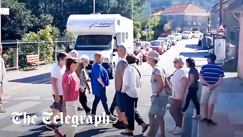 Spanish anti-tourism protesters block beachgoers with 'Abbey Road' style disruption