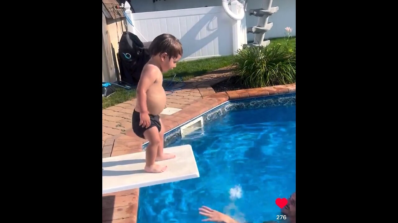 1 year old jumps into pool off diving board. Child learning child development child recreation