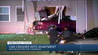 Car crashes into Milwaukee apartment building, hunt for driver