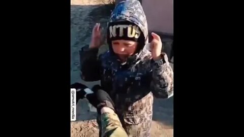 Russian soldier with a Ukrainian child