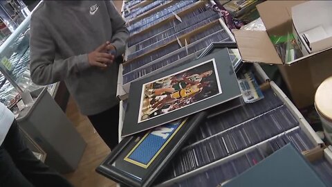 Sports card store owner surprises boy who lost card collection in Denver house fire