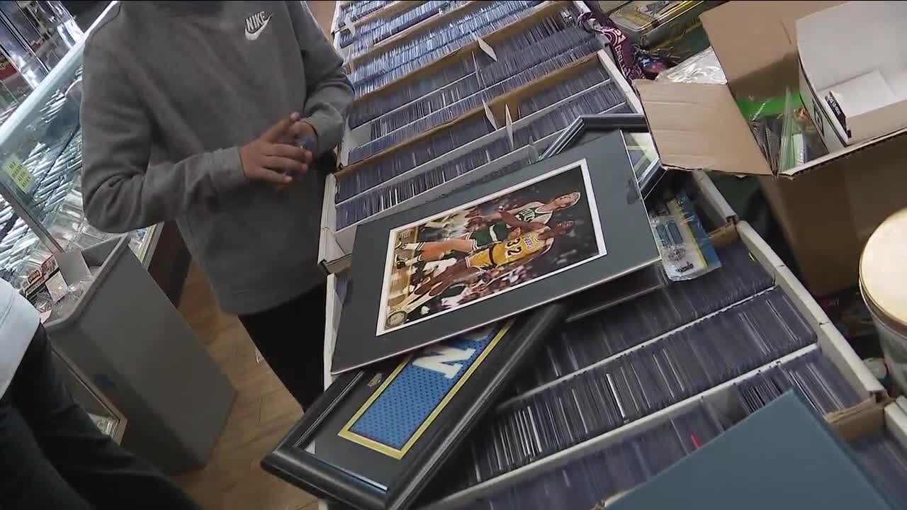 Sports card store owner surprises boy who lost card collection in Denver house fire