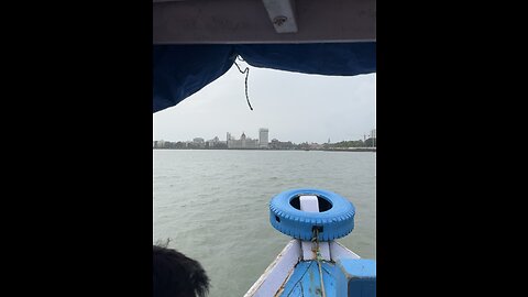 Mumbai on boat and show Taj hotel and gateway of india