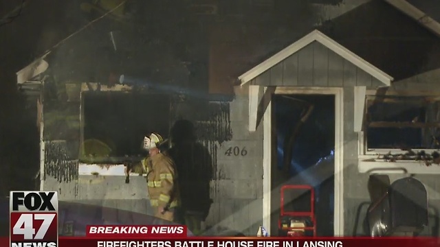 Firefighters battle house fire in Lansing