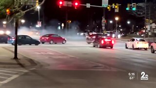 Street racers perform donuts outside Baltimore Police headquarters