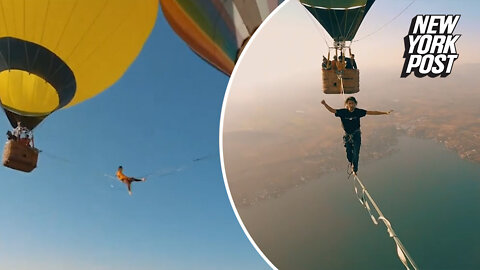 Walking on air: Sky-high stunt between two hot air balloons