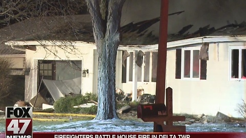 Firefighters battle house fire in Delta Township