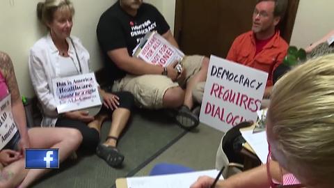 Angry over health care plan, protestors stage sit-in at Sen. Johnson's office