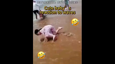 Cute baby reaction to waves