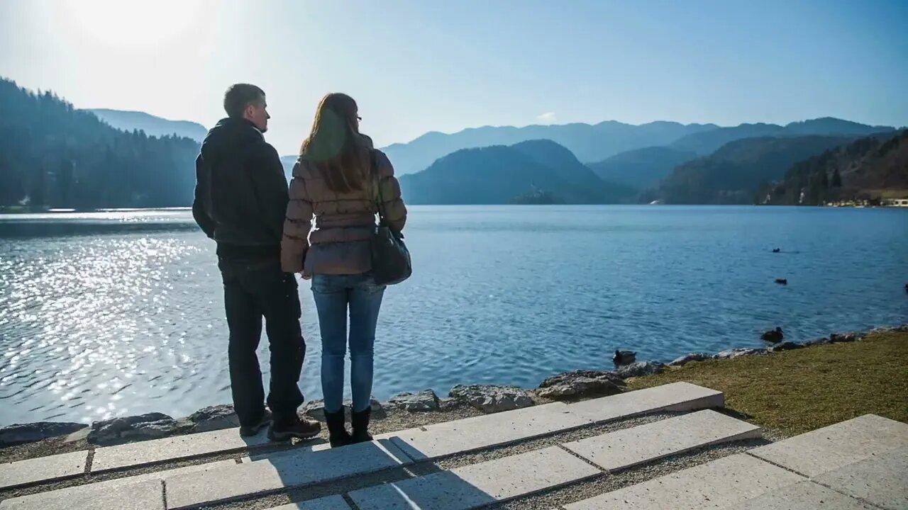 Two person enjoy lake Bled view on sunny day