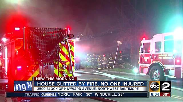 Three safely escape from massive Baltimore house fire