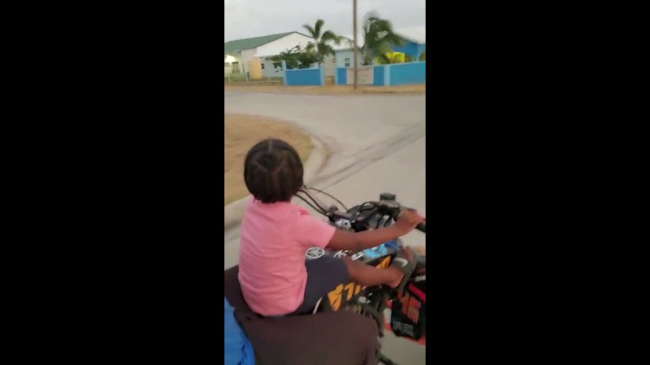 Young Kid Driving A Four Wheeler Bike