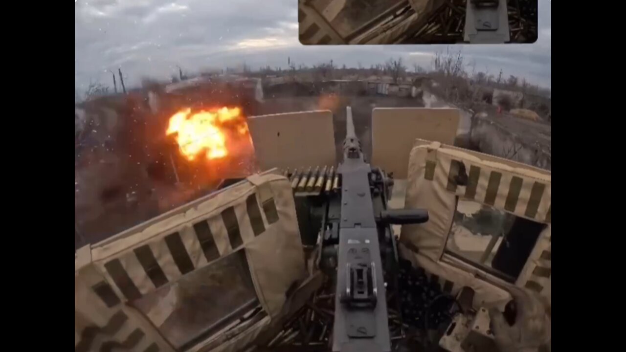 A Ukrainian gunner from a US MRAP MaxxPro fires on Russian positions