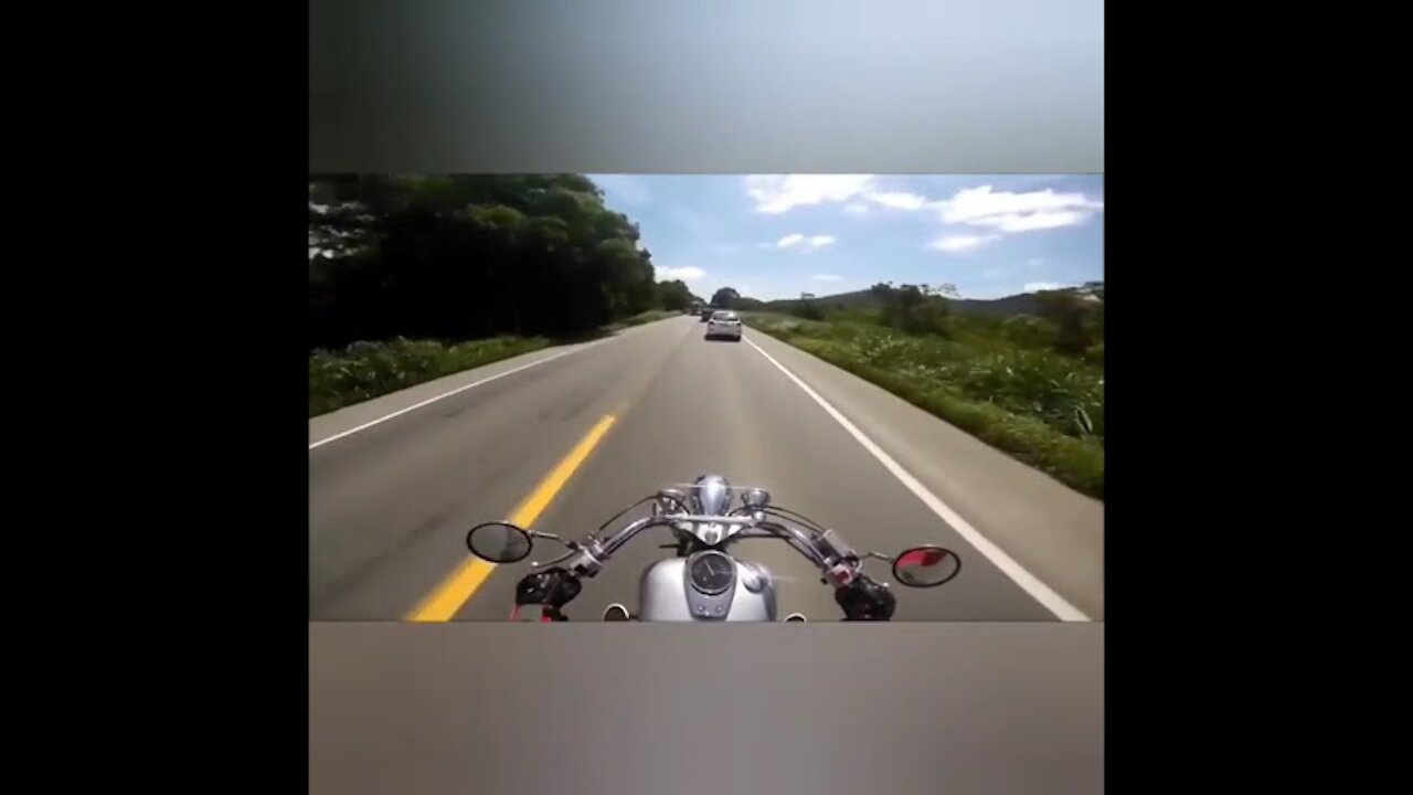 Skillful biker maintains control during high speed on highway