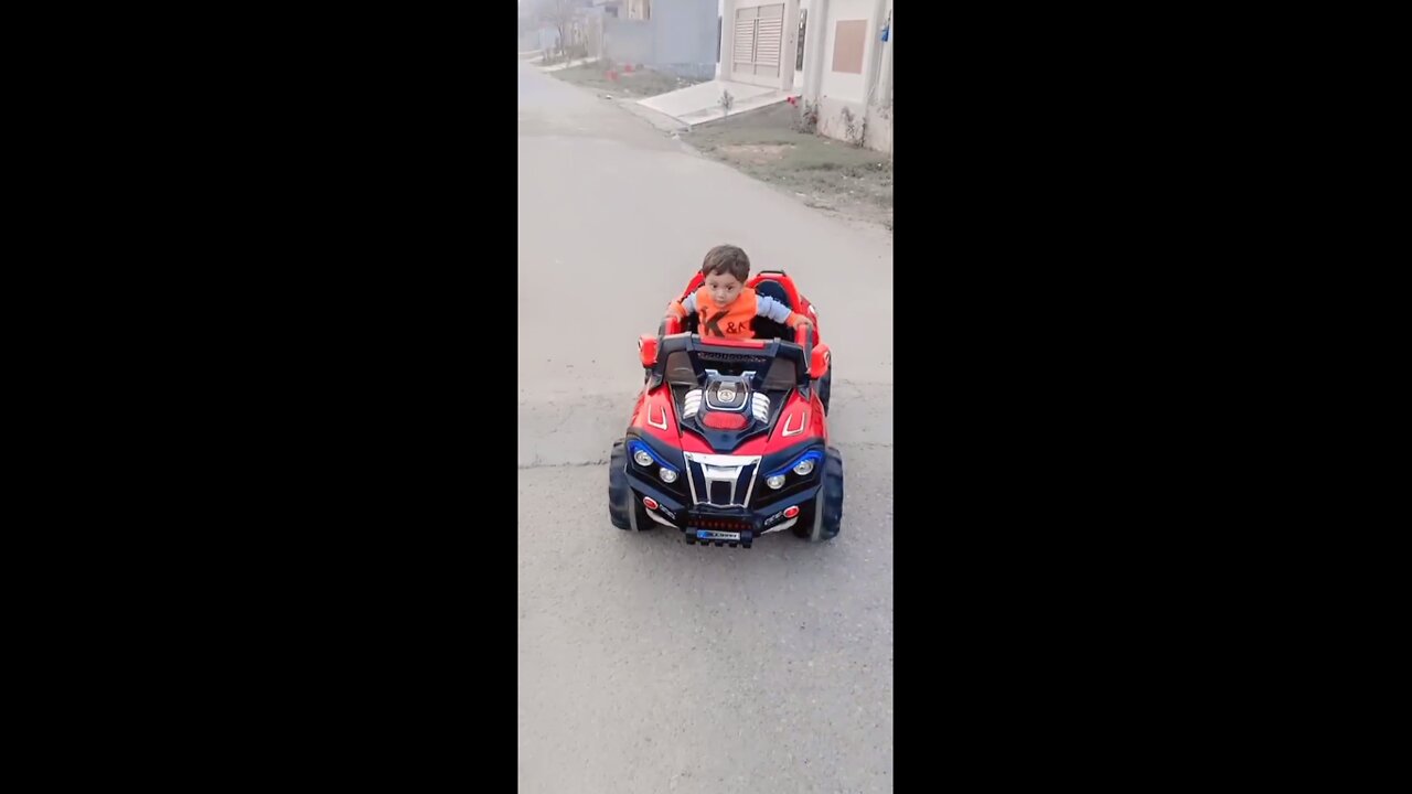 Cute baby enjoying his toy car