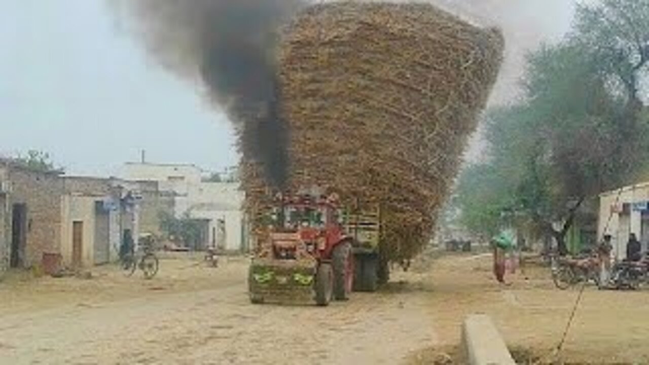 Powerful Tractors are pulling trailers in turns Belarus farmer Tractor are emitting a lot of smoke