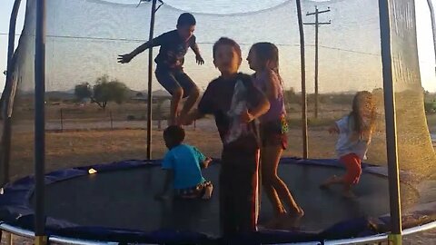 The Kids Jump on the Trampoline