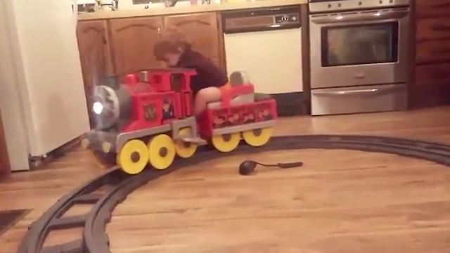 Tot Boy Falls Asleep On A Toy Train