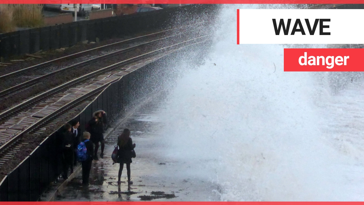 Children risking their lives by dodging huge waves on the wrong side of a seawall