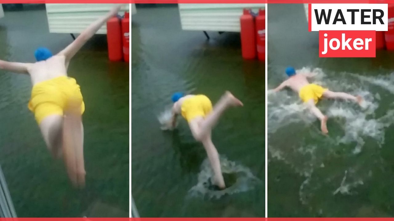 Holidaymaker jumping into floodwater