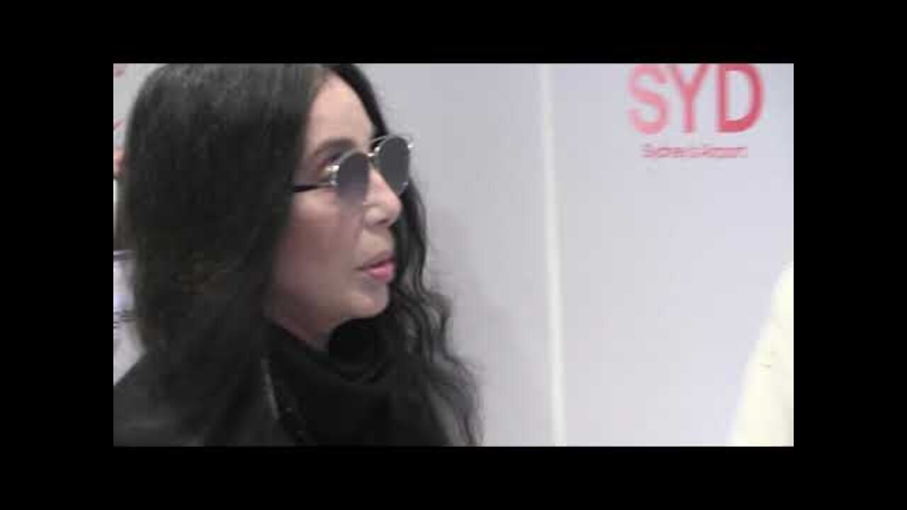 'Cher silent as her minder pushes and shoves cameraman at Sydney airport'