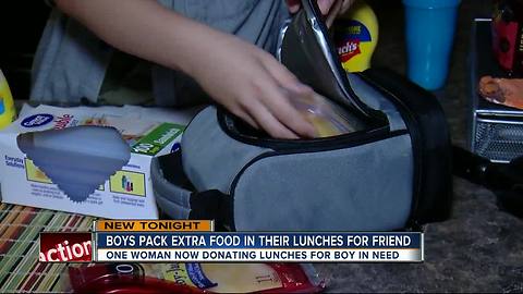 Two Pasco County students sharing sandwiches for student in need