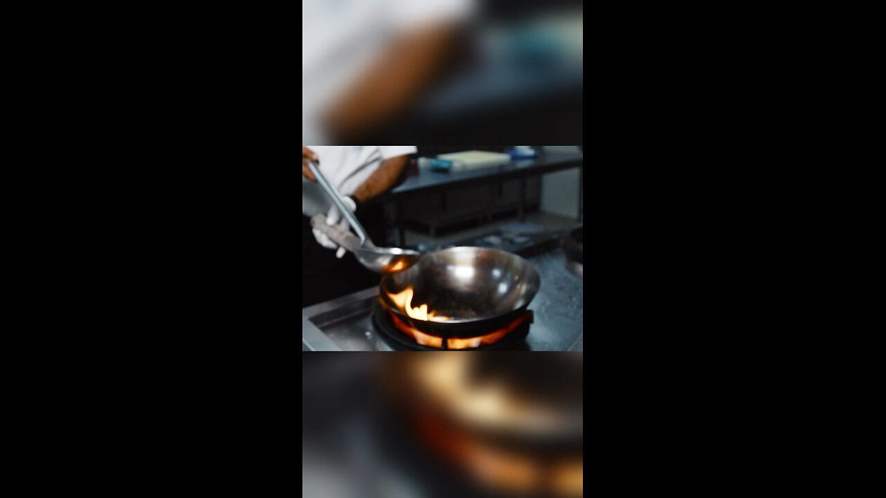 A man cooking food very quickly and eating