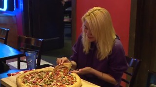 Hot dog-eating champ eats pizza in record time in Las Vegas