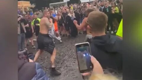 Two men fighting at festival stop to dance when the beat drops