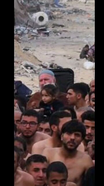 small girl in this photo Detained by Israeli occupation forces amongst 100s of half undressed men.
