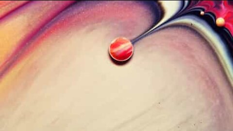 Artists creates mini planets with ink drops