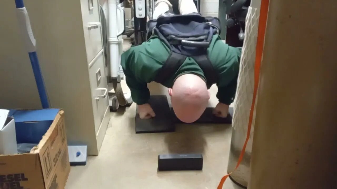 Quick 1 Minute Pushup Isometric 5 Second Hold On Knuckles Wearing 25 LB Pack Feet Elevated On Chair.