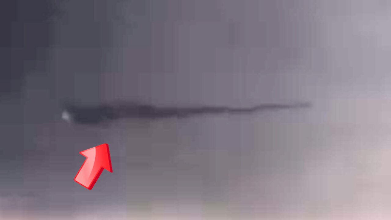 Elongated UFO moving at the speed of light in the sky above [Space]