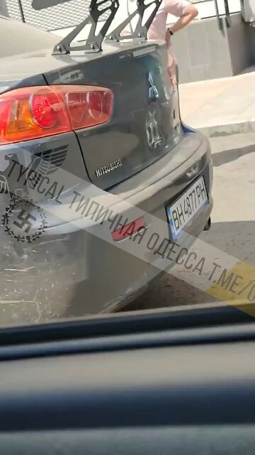 Ukraine military in a civilian car with Nazi symbols driving around Odessa