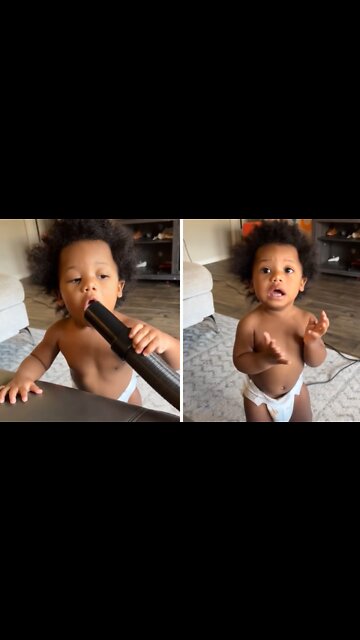 Baby learns the hard way not to play with the vacuum