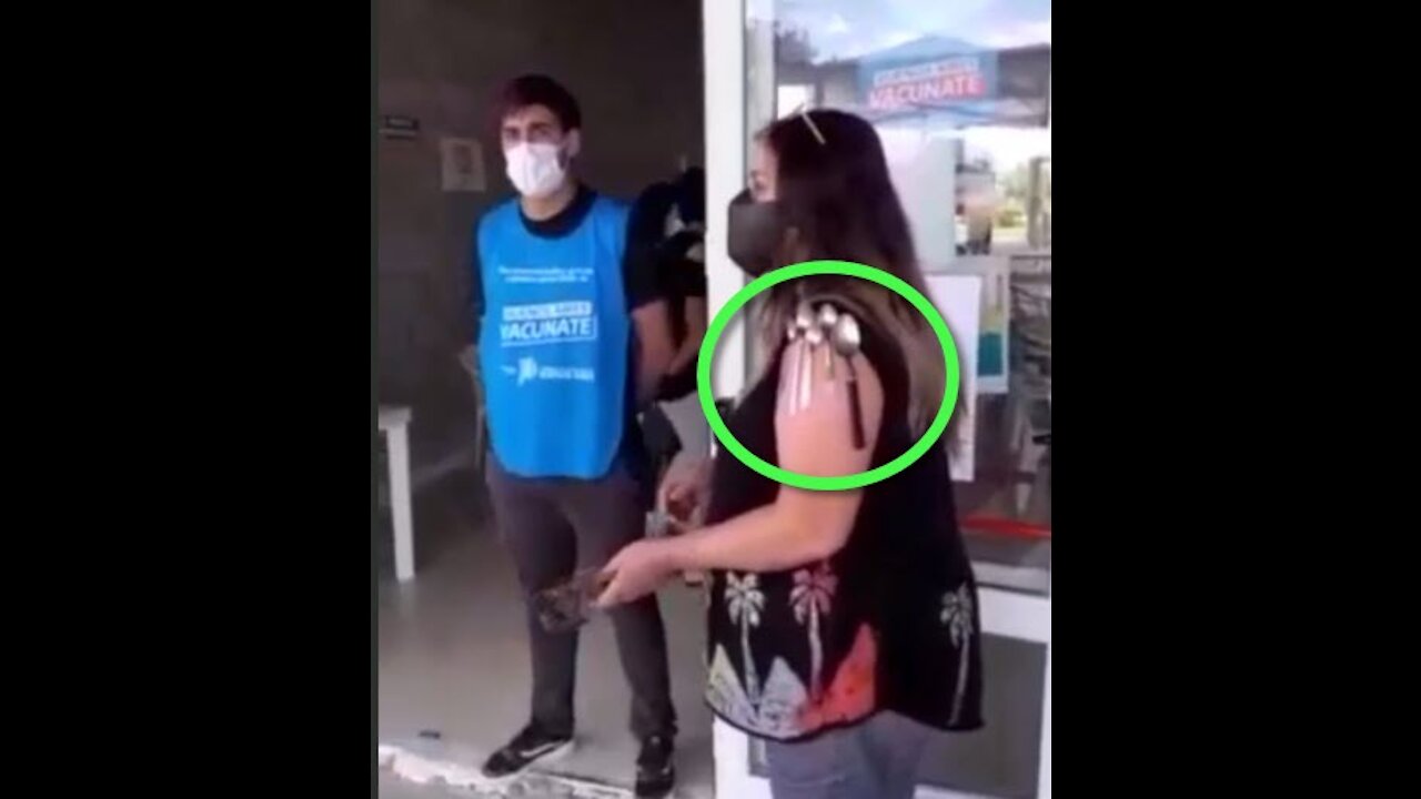 Woman trying to warn a sheeple in front of the "vaccination" site