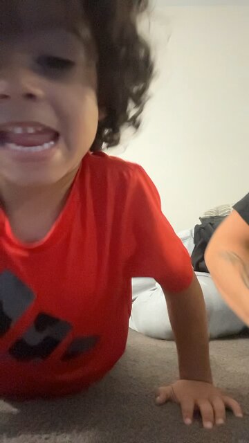 Teaching him how to do push ups