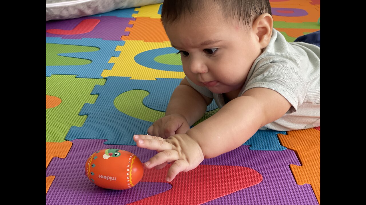 Baby plays with a shaker egg