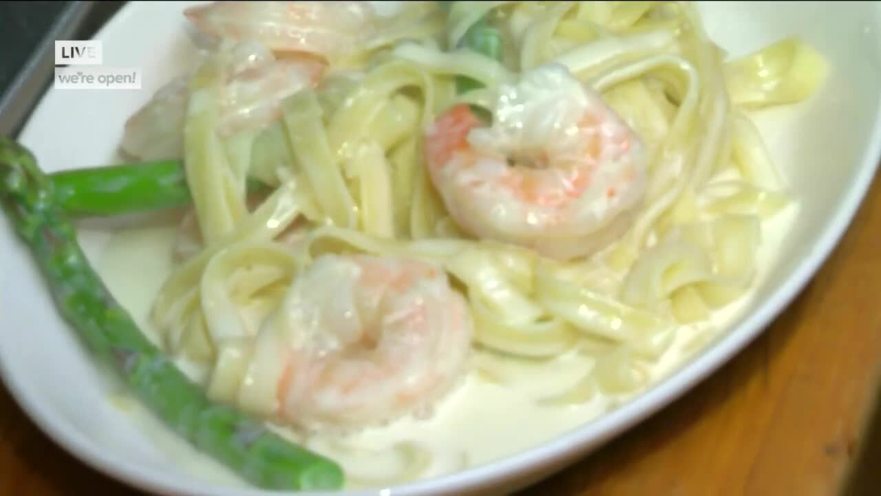 Cooking shrimp alfredo at Dobie's Steak House