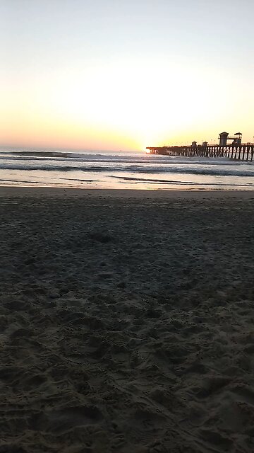 Oceanside , California Surfers in time lapse at sunset at the pier