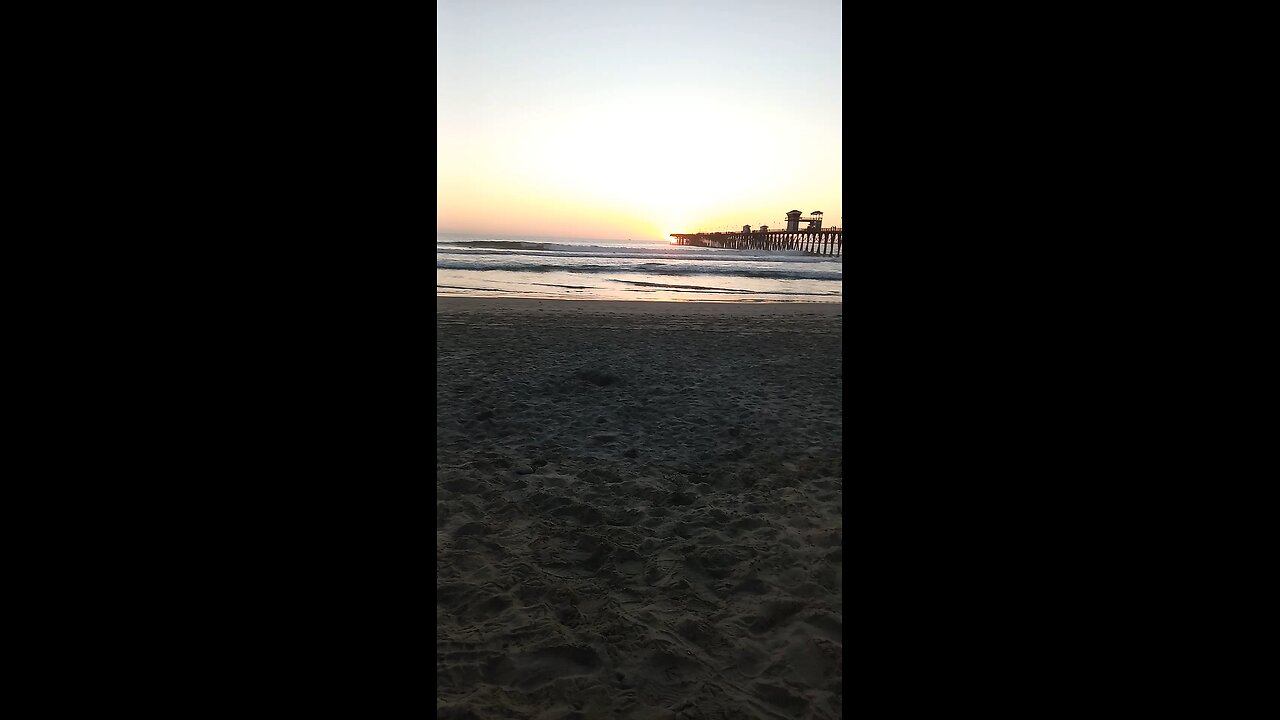 Oceanside , California Surfers in time lapse at sunset at the pier