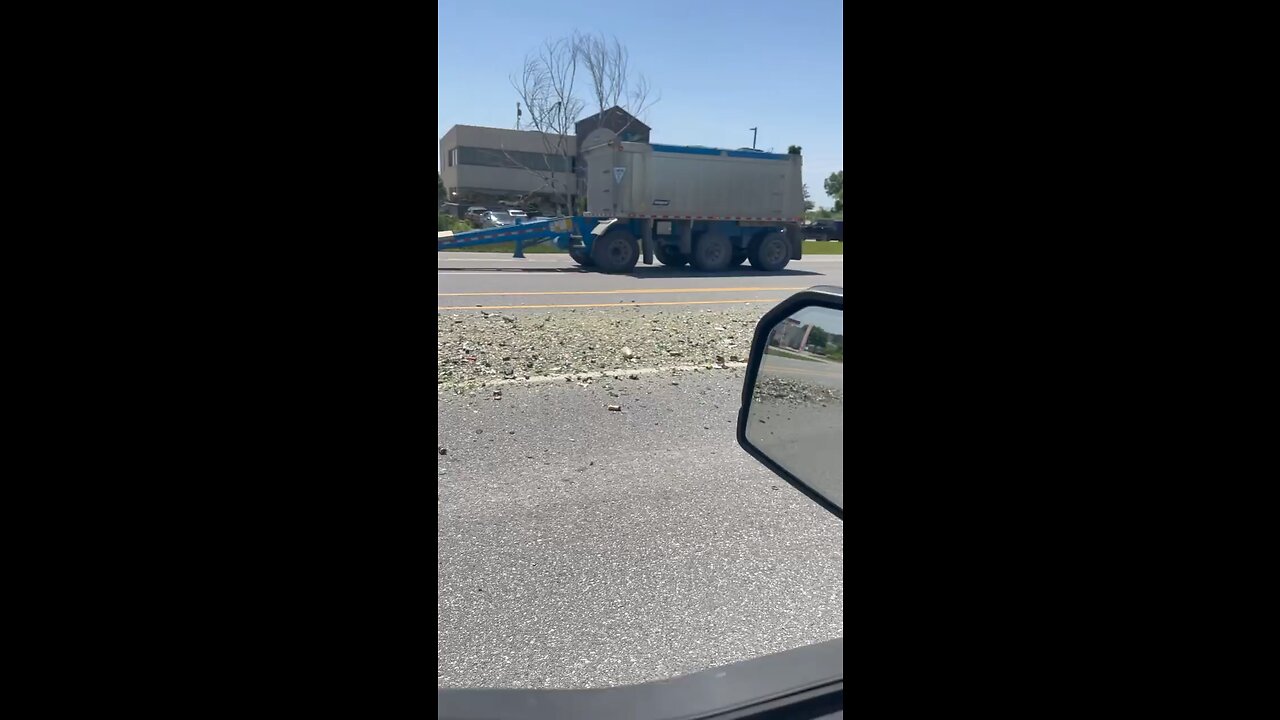 Dump Truck Drops Gravel On Highway