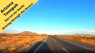 Arizona Tonopah Driving in the desert with the sun setting at our backs 1