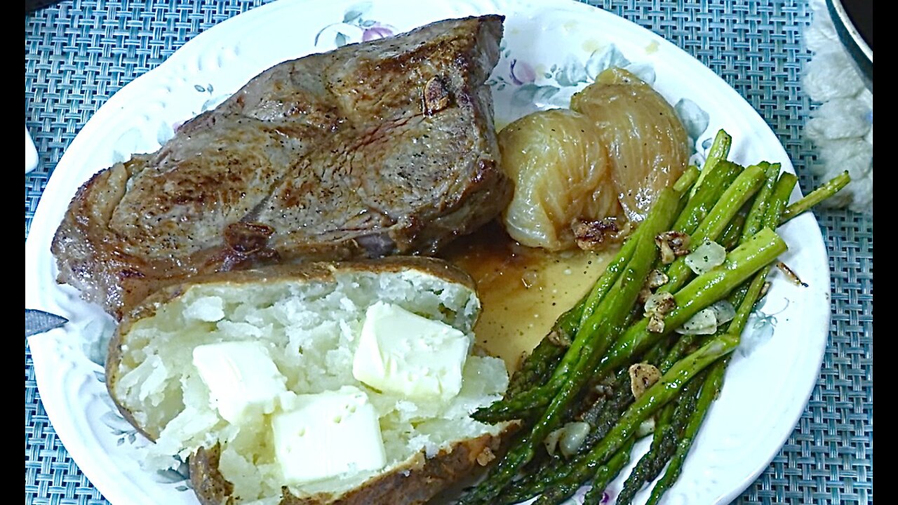 NY strip steak, sautéed asparagus w/ baked onion & potato