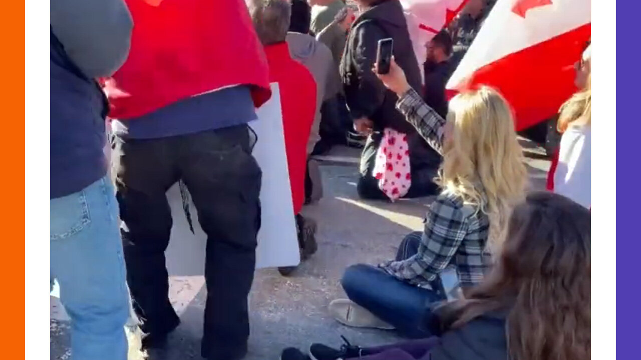 Canadians Sit On Road To Block Cops