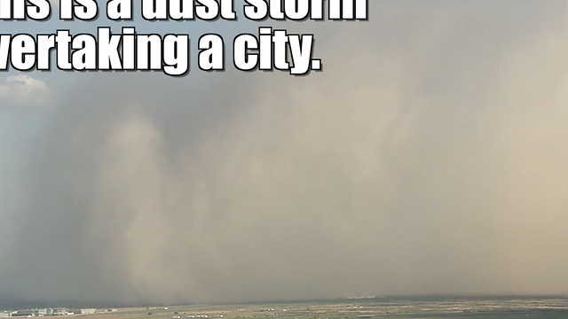 Dust storm overtakes a city