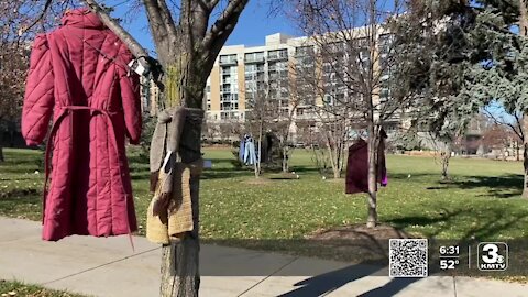 Secret Kindness Agents fill Turner Park with free warm clothing items for those in need.