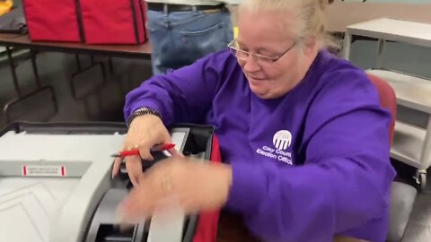 Workers check ballot boxes